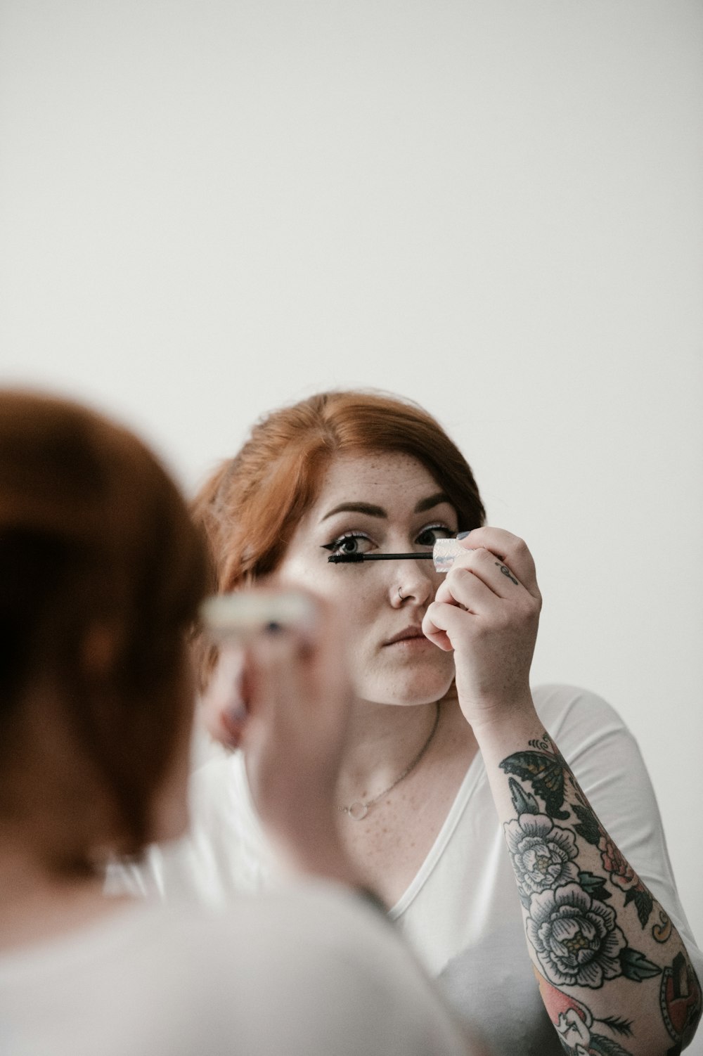 woman using makeup during daytime