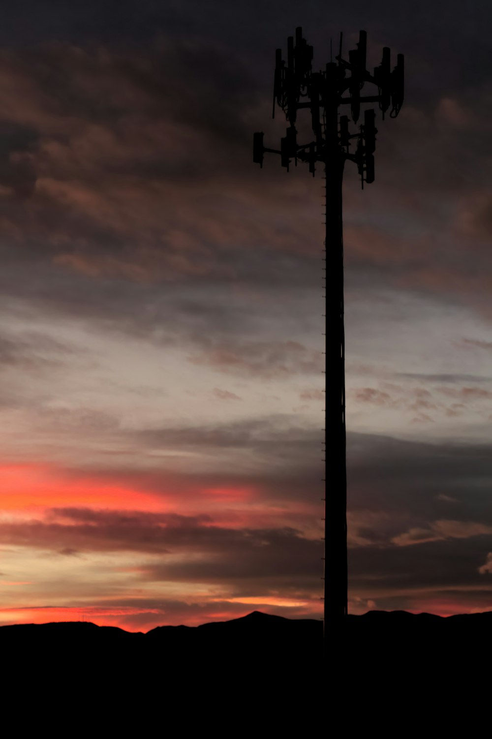 silhouette of network tower at golden hour