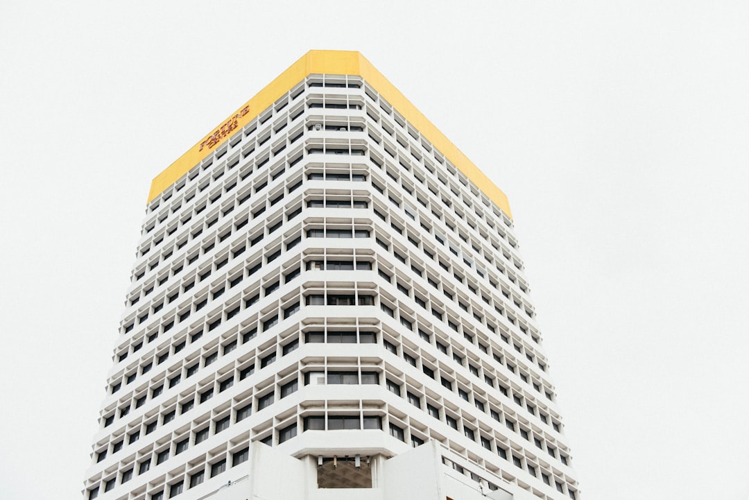 white and yellow tall building under white sky