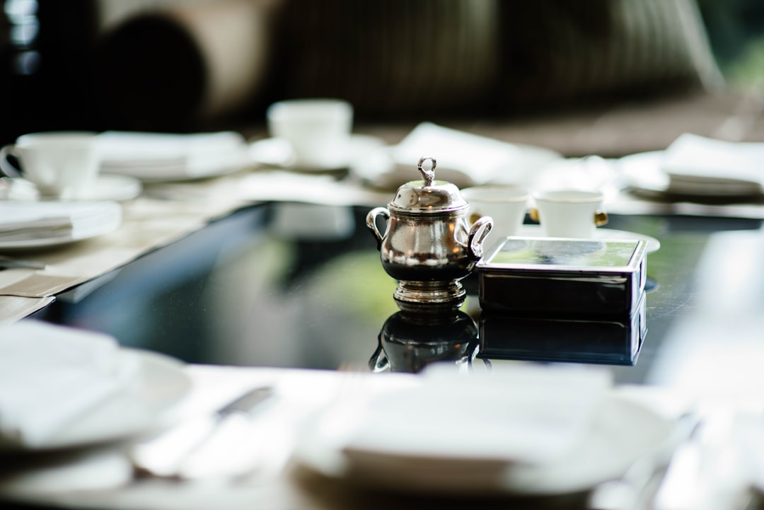 selective focus photography of teapot on table