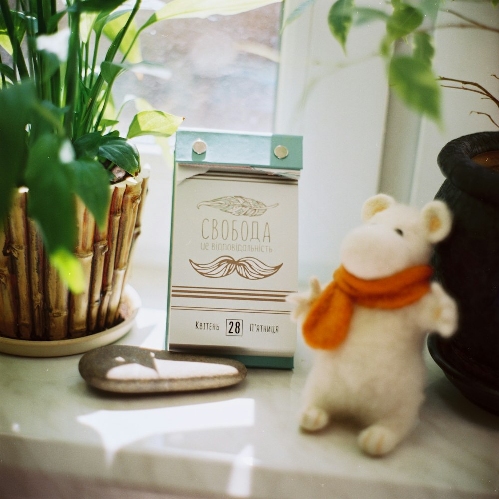 white mouse table decor near leafed plant