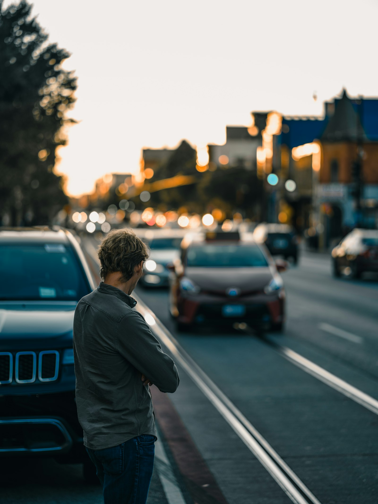 Sony a7R II + Sony FE 85mm F1.8 sample photo. Man standing near vehicle photography