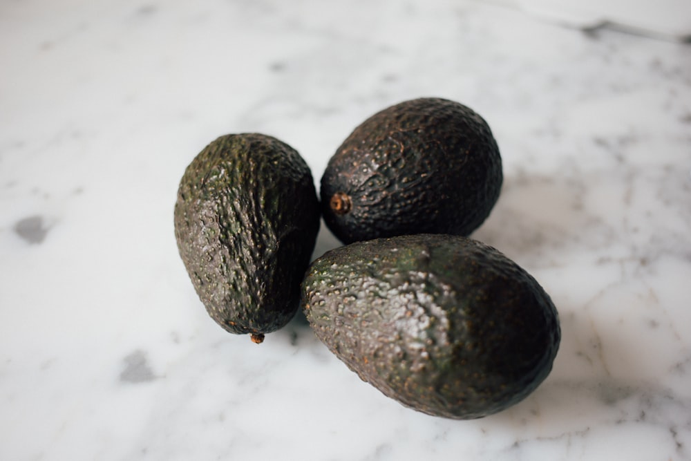 three green avocados