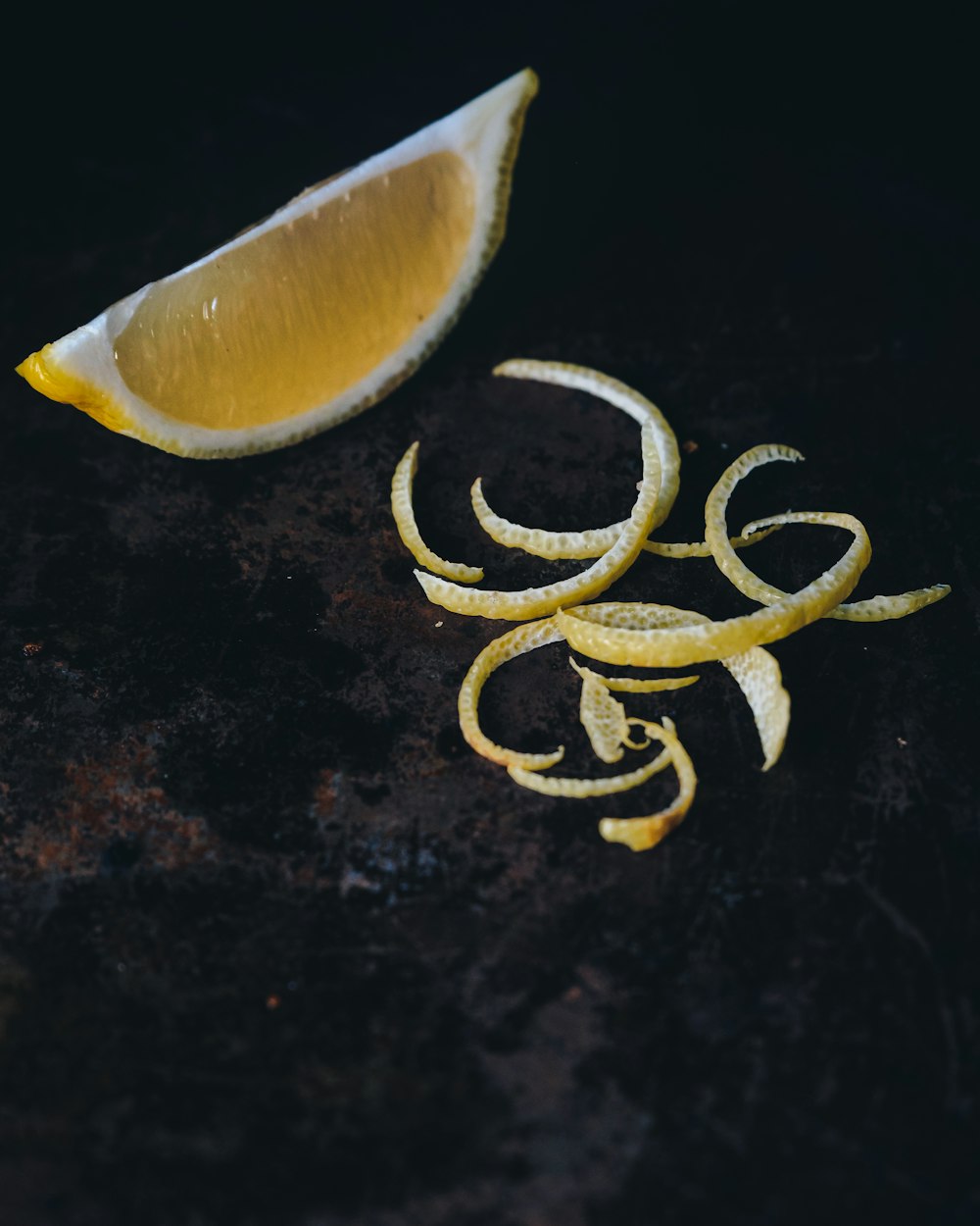 slice of lemon on black surface