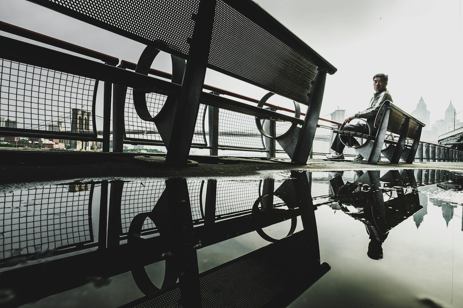 ZEISS Touit 12mm F2.8 sample photo. Man sitting on bench photography