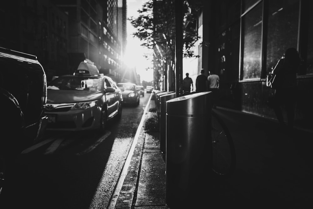 grayscale photo of trash bins