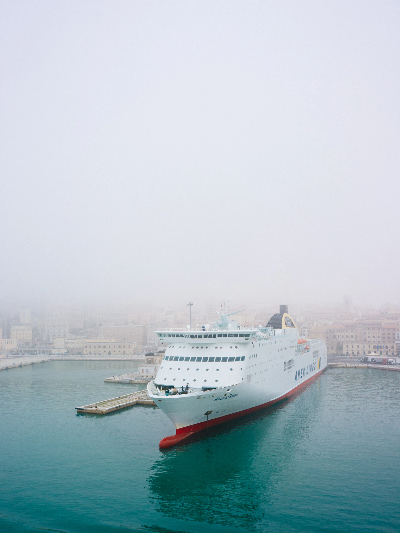 A cruise ship emerging from heavy fog as it approaches port, evoking the avoidable missteps that can sink a cruise injury claim