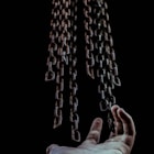 man's hand and chains