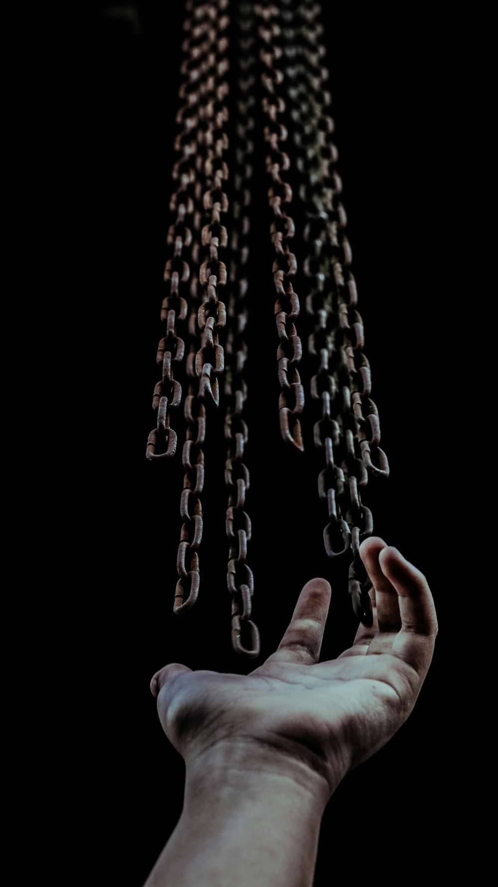 man's hand and chains