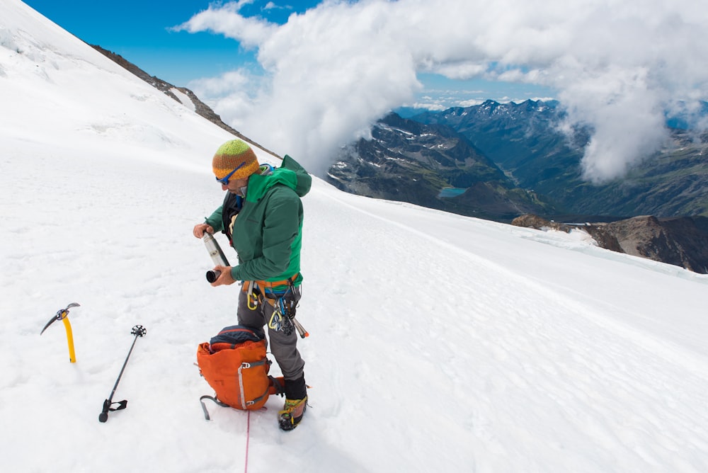 man in snow field mountain at daytime