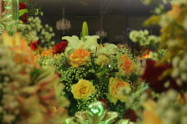 Artistic arrangement of church florals blending modern romantic style with rich greenery and delicate blooms.