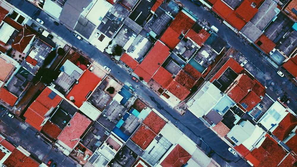 bird's eye view of red roofed houses near roads