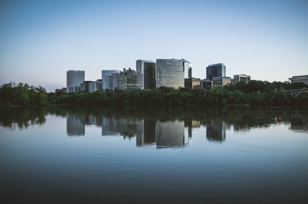 buildings with reflection on water at daytime