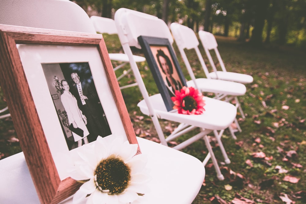 brown wooden photo frame on white folding chairs