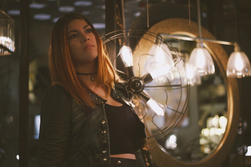 woman standing near pendant lamp