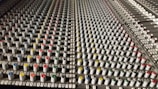 Professional audio mixing console with colorful knobs and sliders.