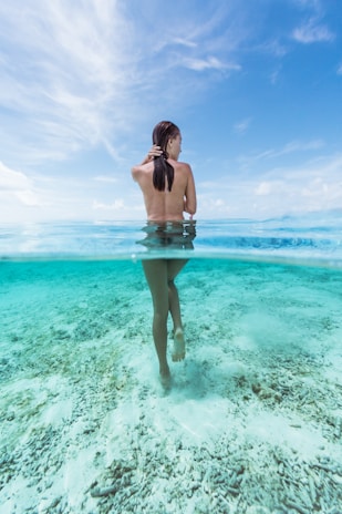 naked woman in water at daytime