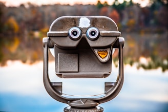 closeup photo of telescope facing water