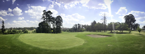 A sunlit view of the lush green fairways winding through mature trees at Pavenham Park Golf Club.