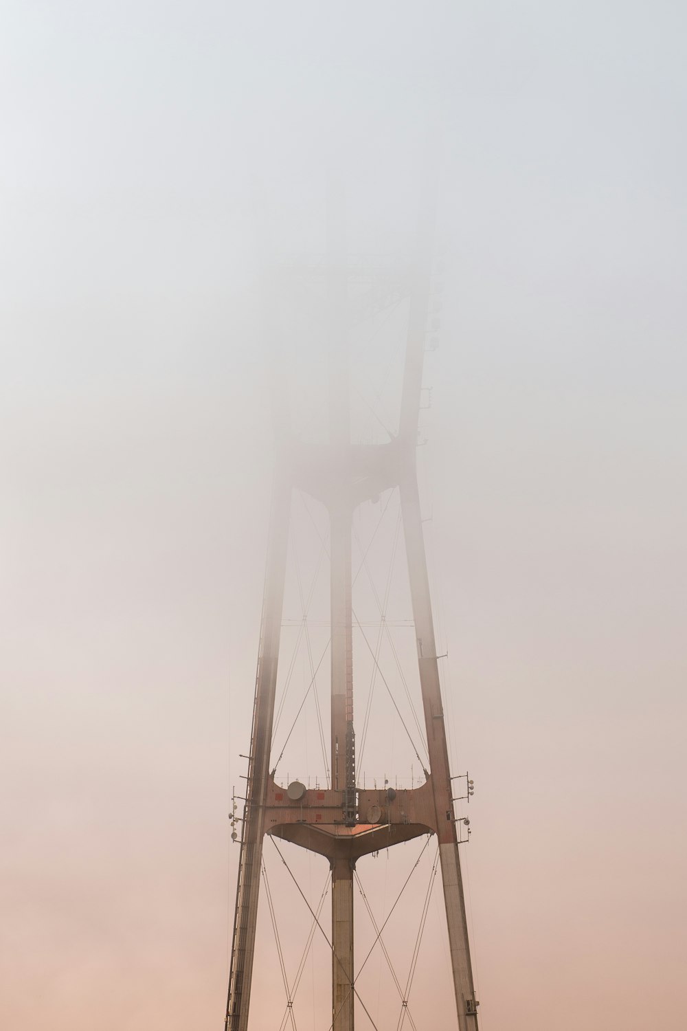 gray network tower covered by white clouds