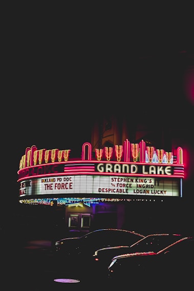 A vibrant movie theater marquee glowing at night with the name 'mclucien plus' shining brightly.