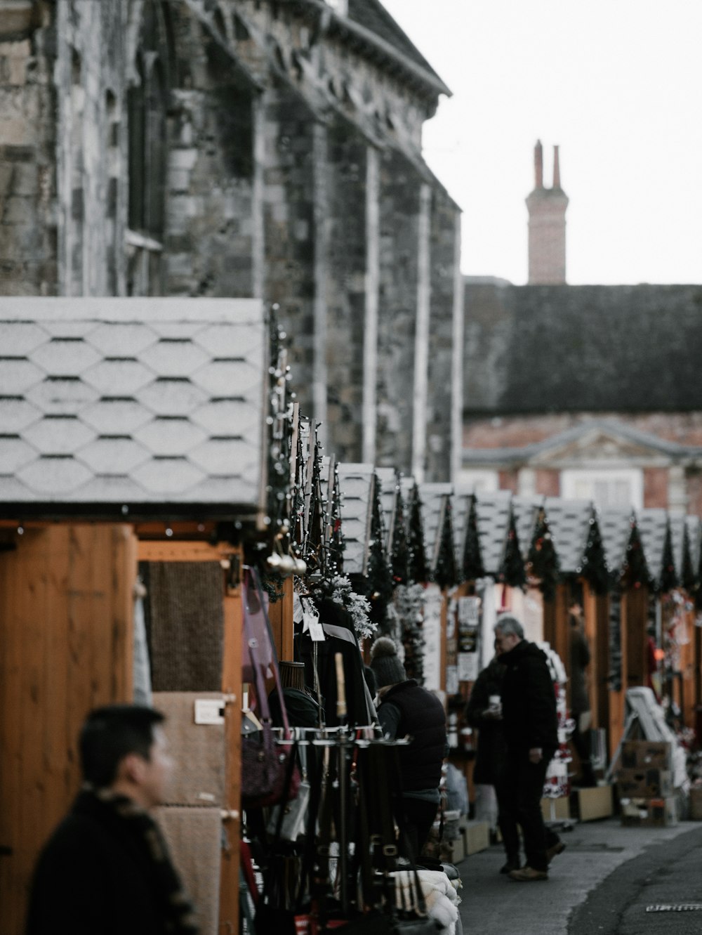 people in an area filled with store stalls