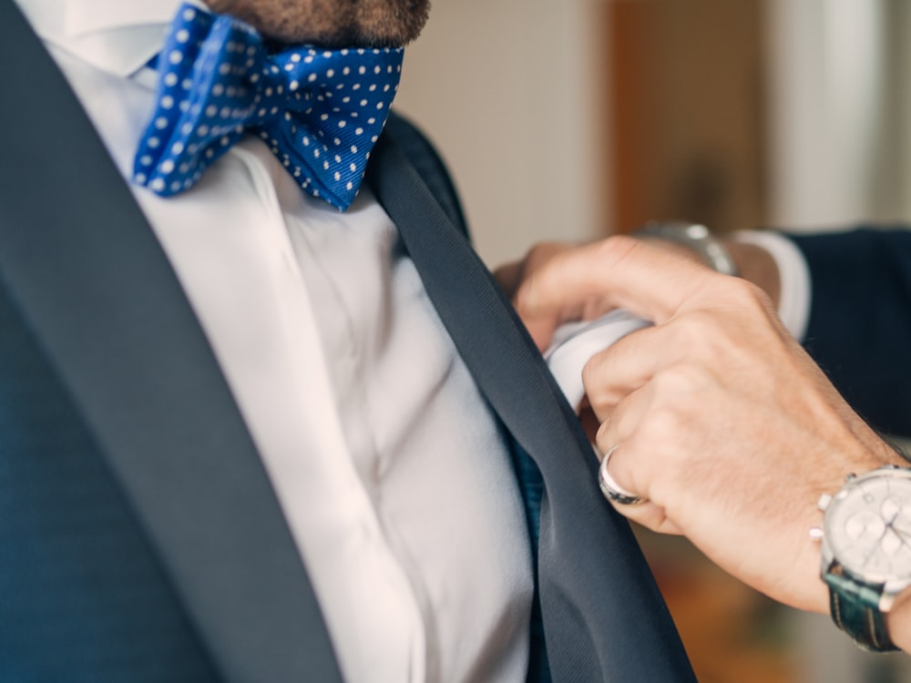 man wearing blue and white polka-dot bowtie