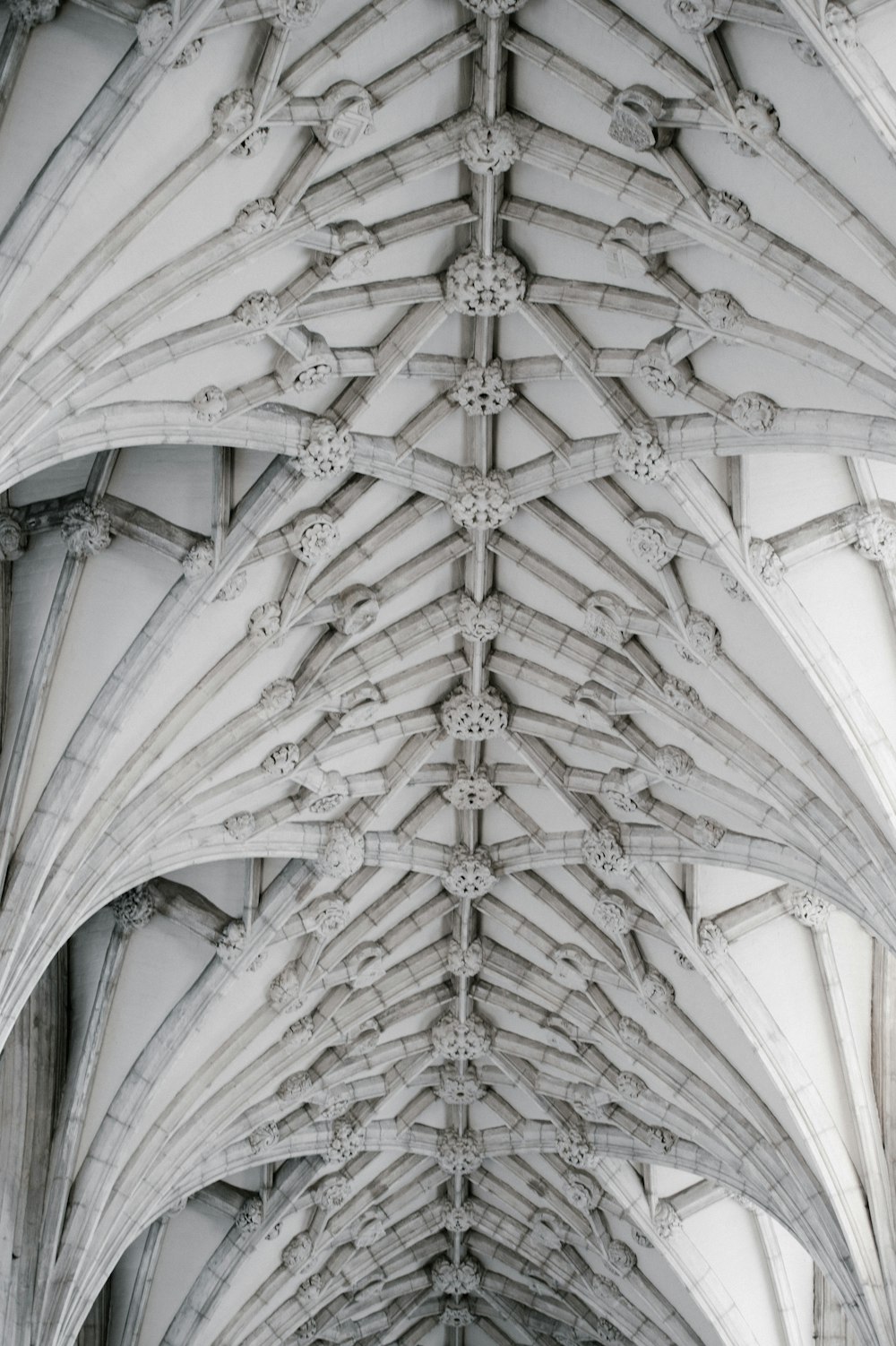 the ceiling of a large building with a clock on it