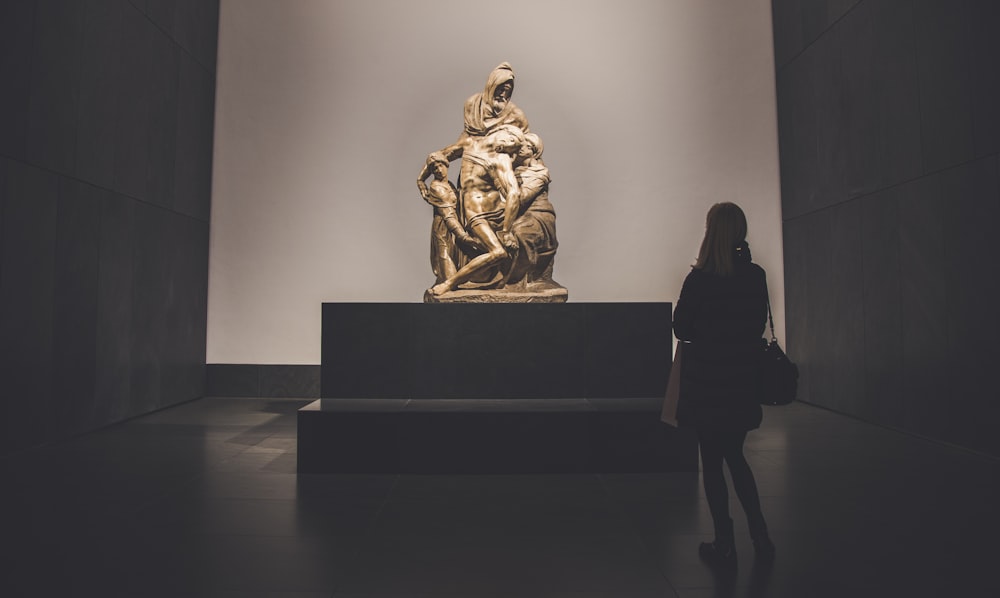 person standing near statue inside museum