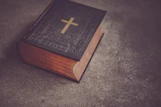 black Bible on gray surface