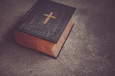 black Bible on gray surface