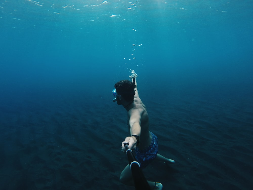 person under body of water