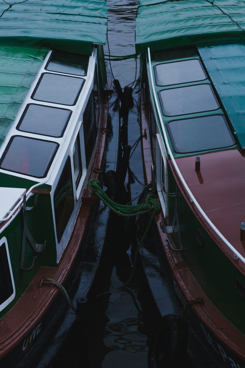 closeup photo of two boats side by side on body of water