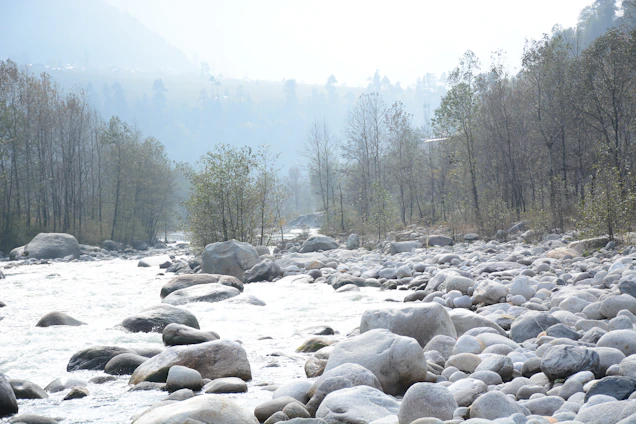 A calm river flowing through a rocky landscape symbolizing the connection between earth and water.
