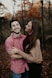 woman hugging man selective focus photography