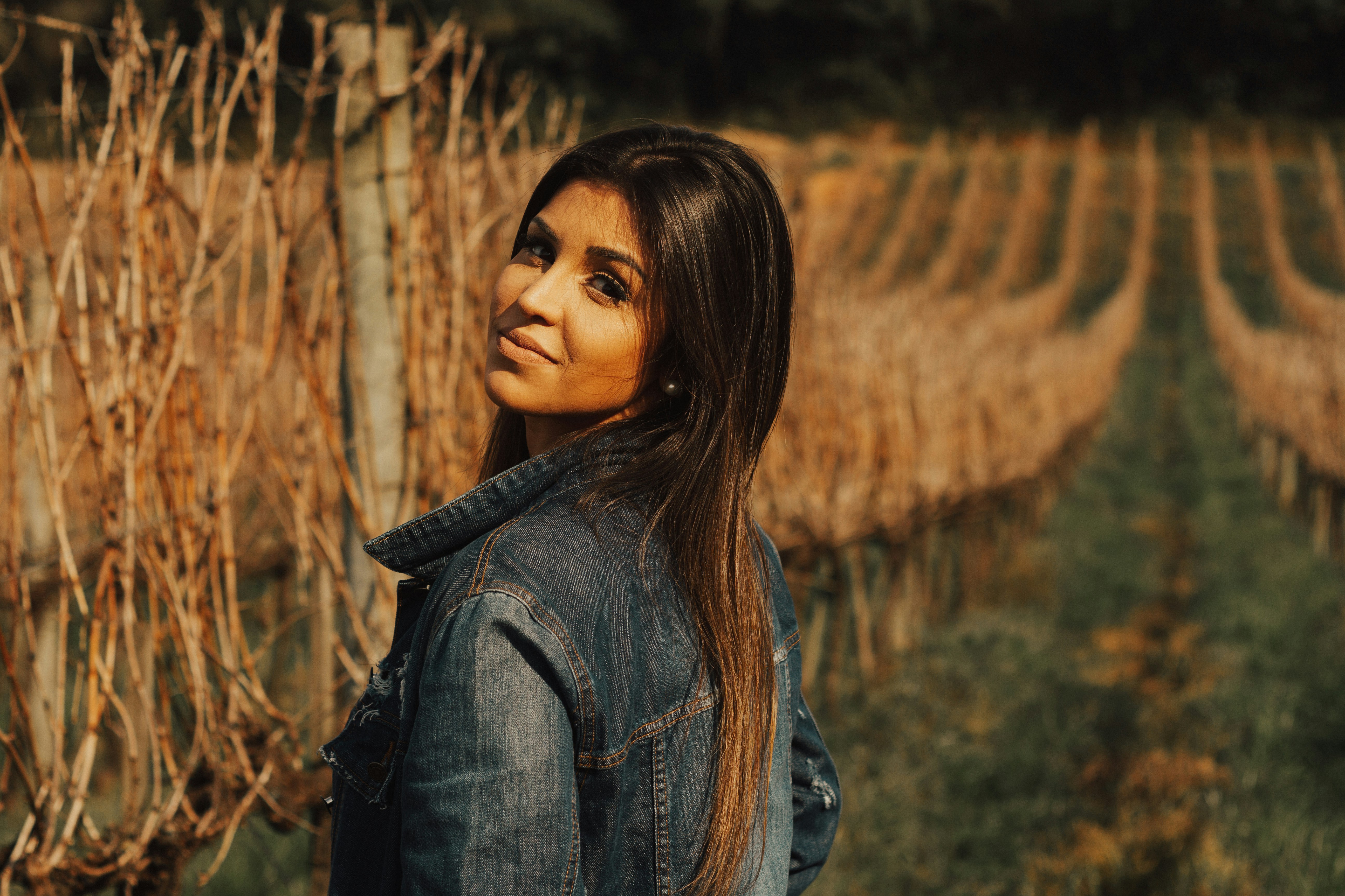 woman standing near brown vines