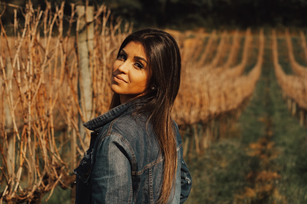 woman standing near brown vines