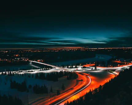 A dynamic aerial shot of illuminated highways converging under a twilight sky, symbolizing swift connectivity.