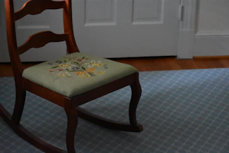 A serene therapist’s office with soft pastel blue walls and a comfortable chair.