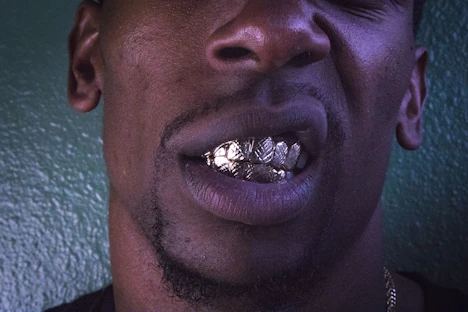 man leaning on green painted wall