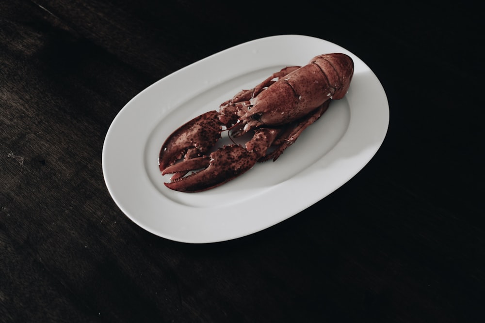 cooked lobster on white ceramic plate