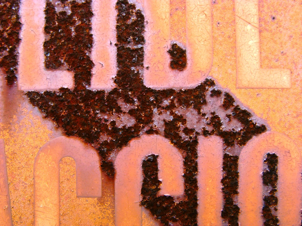 a close up of a street sign with dirt on it
