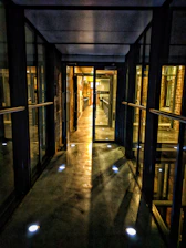 An immersive virtual corridor with multiple doors leading to industrial workspaces.