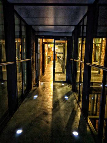 An immersive virtual corridor with multiple doors leading to industrial workspaces.