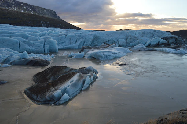 A wide-angle view of a frozen glacier reflecting soft morning light.