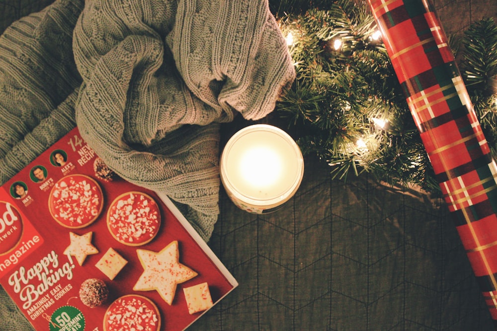 candle beside string light and garland