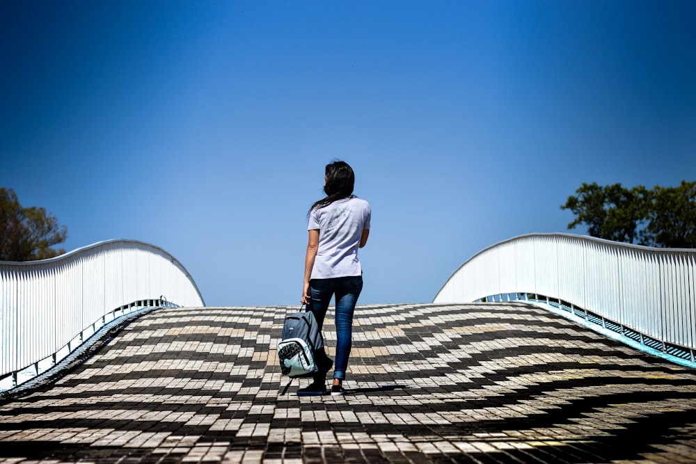 man walking on bridge at daytime