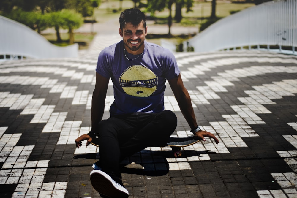 man in gray t-shirt sitting on skateboard