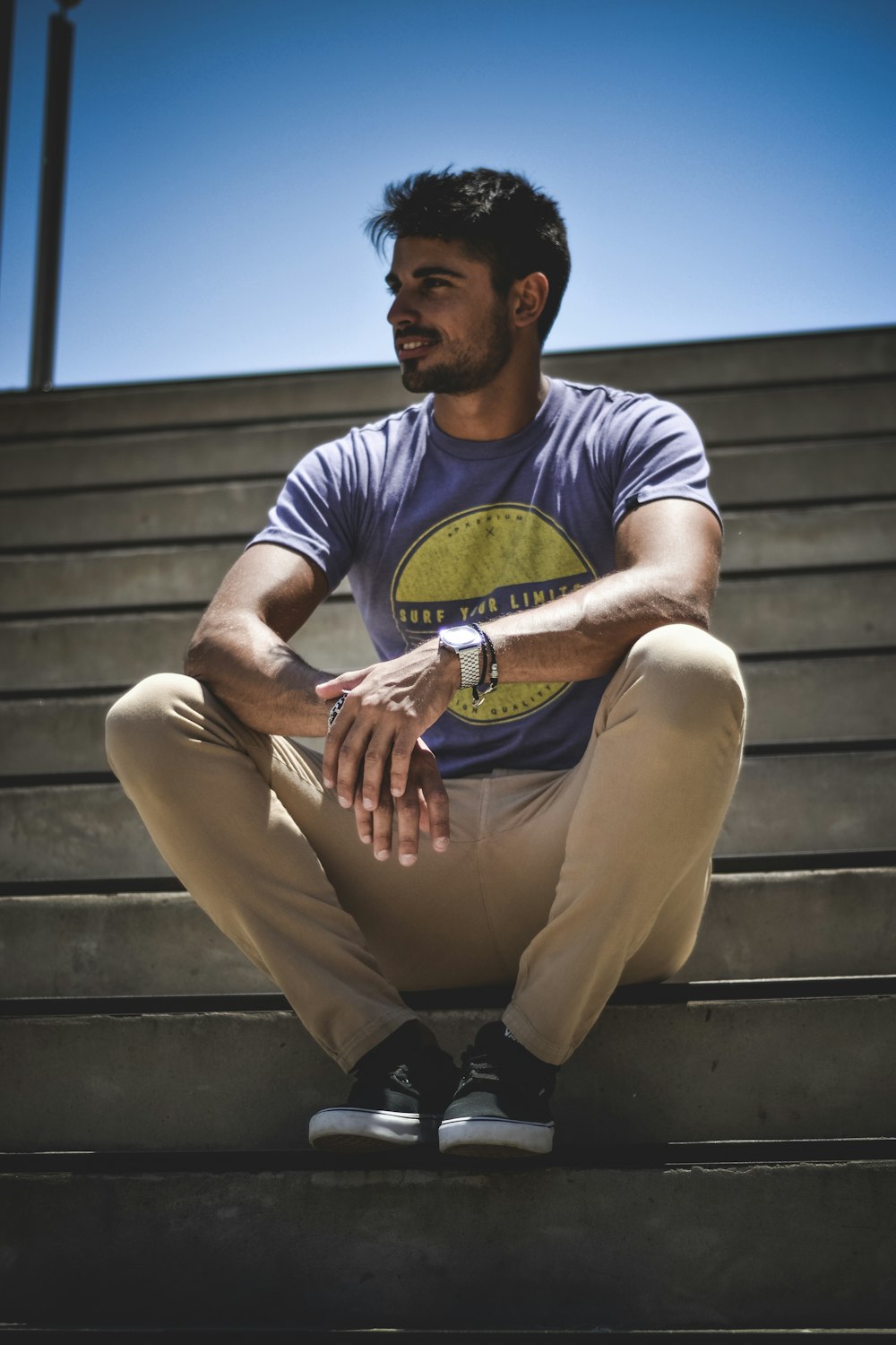 man sitting on gray stairs