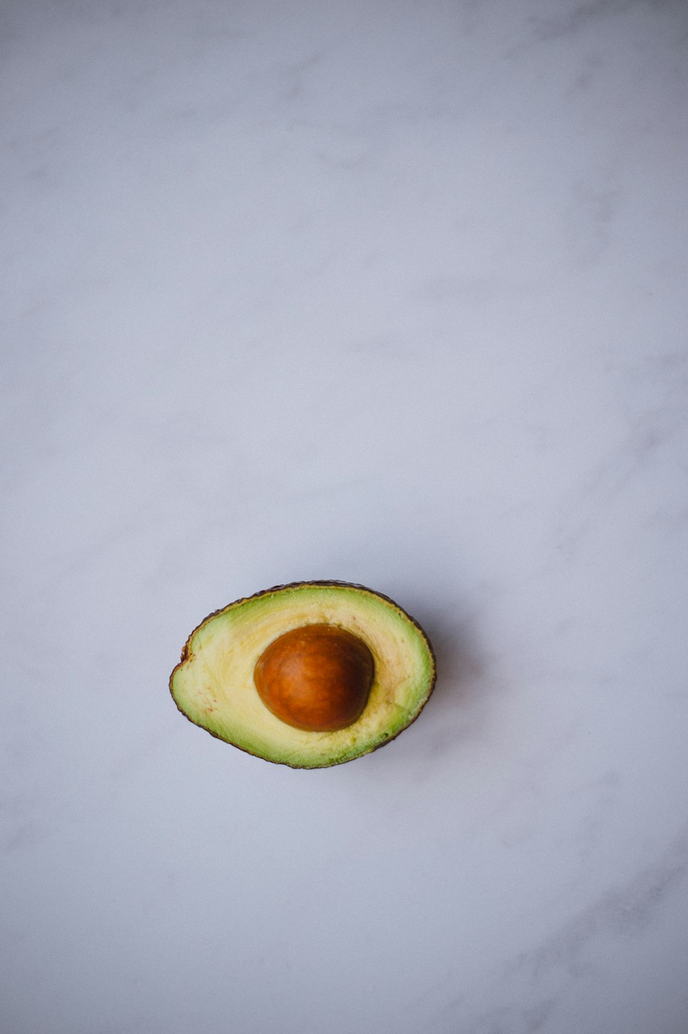 photo of avocado on white surface
